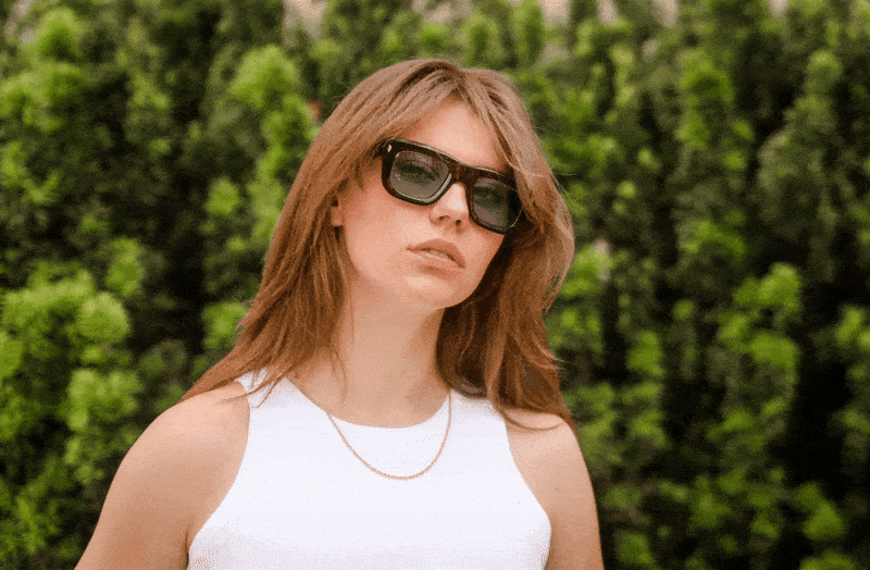 Campaign photography for Optician Kästner Stuttgart showing a model wearing sunglasses in a natural outdoor setting GIF